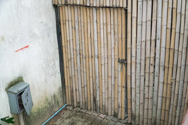 A handmade bamboo door on bamboo wall