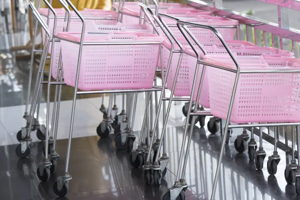 small shopping carts pink color in a Retail department store.