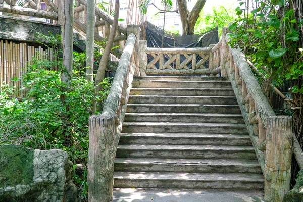 Concrete brick stairway leading up a walkway through the jungle with trees, Dam concrete ladder, Old concrete