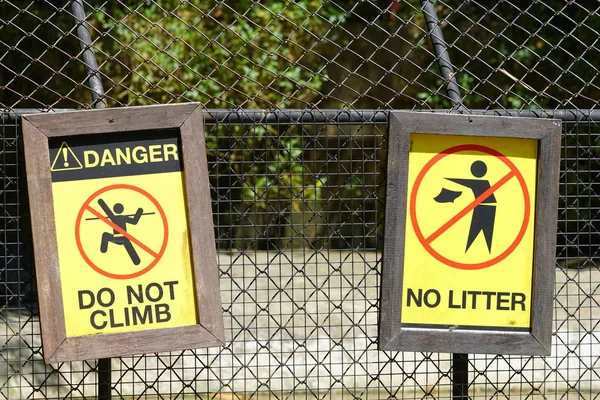 do not climb and no littering warning sign Crocodile Farm in Thailand