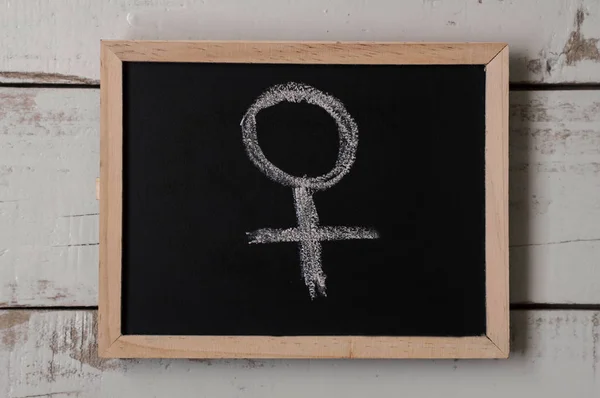 Venus symbol drawn on blackboard. Female symbol. Women\'s rights concept. Feminism
