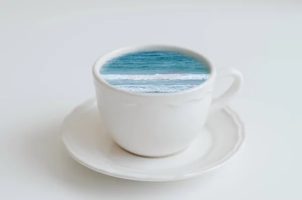 Sea in a coffee cup. Ocean in a mug, creative idea. Coffee break concept