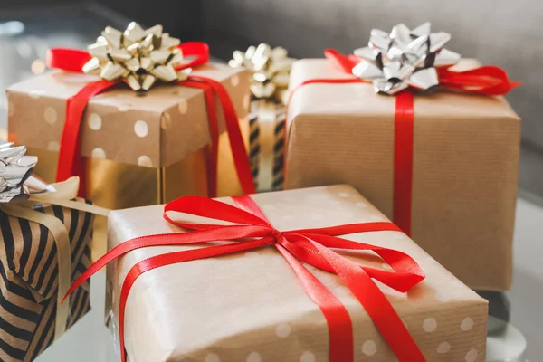 El işi kağıdına sarılı kırmızı kurdeleli kutular. Noel ve Yeni Yıl Hediyeleri