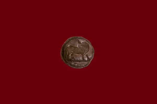 An ancient coin, a former means of payment made of metal