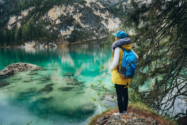 Girl walking near mirror lake in the mountains