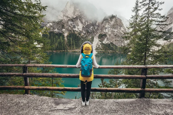 Girl walking near mirror lake in the mountains