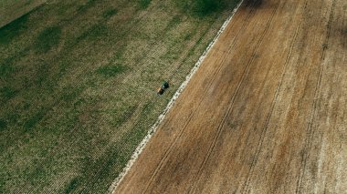 Traktör alanında çalışır. Hava