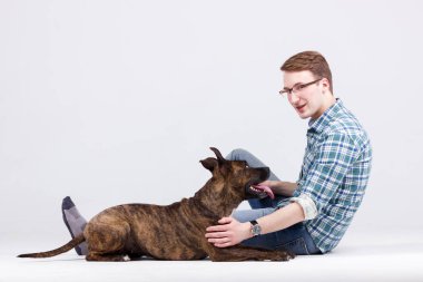 Gömlek ve pantolon güzel delikanlı köpeğini eğitiyor