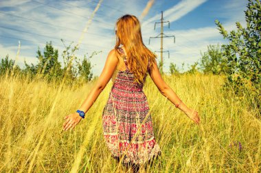 Genç güzel kız aracılığıyla yüksek kuru çim alan ve ishal elinde yaz aylarında yürüyüş.