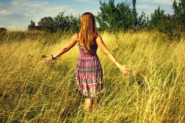 Genç güzel kız aracılığıyla yüksek kuru çim alan ve ishal elinde yaz aylarında yürüyüş.