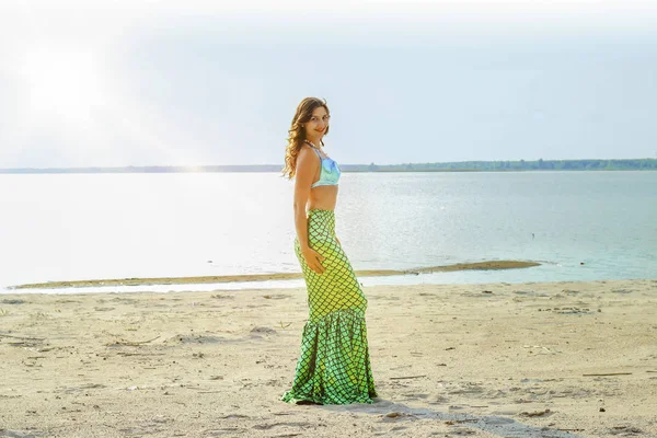 Young beautiful mermaid woman close up standing on the sea cost. Cosplay mermaid.