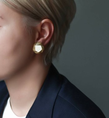 Kızların kulaklarında küpe şeklinde mücevherler var. Yaklaş.