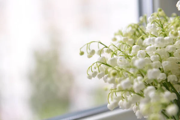 Flowers lily of the valley stand on the table background — Stock Photo, Image