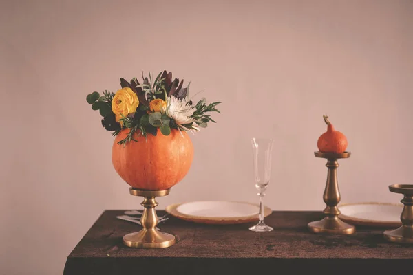 Autumn floral bouquet in a pumpkin vase for Halloween. Table set — Stock Photo, Image