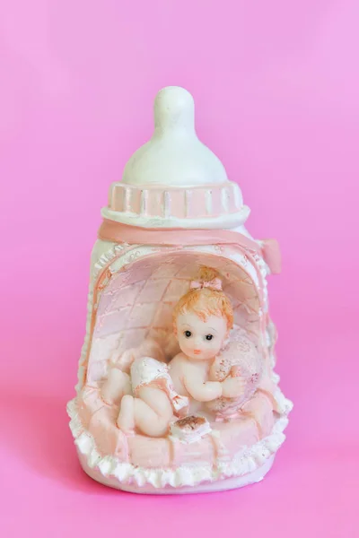 Figurine newborn baby girl in a bed in the form of a milk bottle, decor for baby shower holiday for girls — Stock Photo, Image