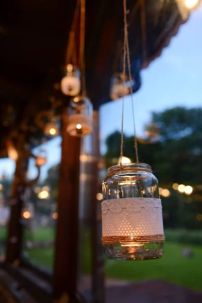 Mason jar candle hanging for wedding decor. Evening light. window