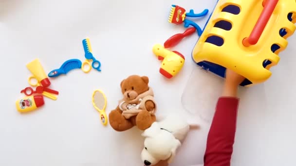 Bebê jogando dentro de casa fundo branco vista superior animais aparador com cão. Espelho e secador de cabelo tesoura — Vídeo de Stock