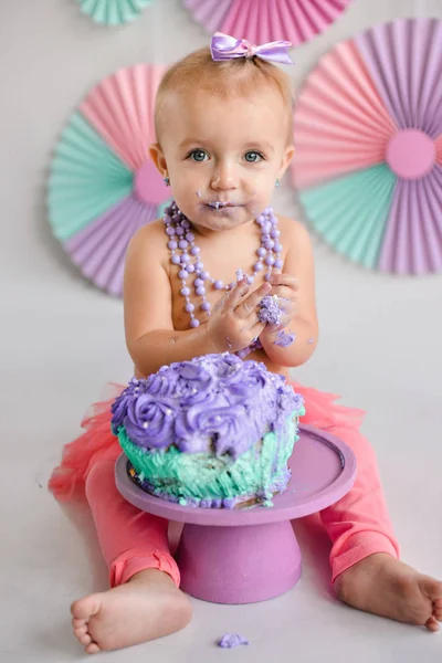 Κορίτσι γενεθλίων ήταν πασαλειμμένος σε μια τούρτα. Η πρώτη τούρτα. Η χρήση του το πρώτο κέικ. Smash κέικ. διακοπές διακόσμηση φωτογραφία πυροβολούν φλερτ κέικ — Φωτογραφία Αρχείου