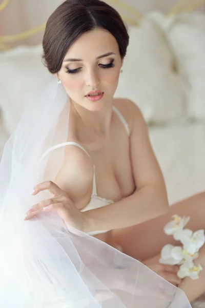 Young attractive female model girl before the wedding. Morning boudoir of the bride. Beautiful lingerie and dress, delicate image — Stock Photo, Image