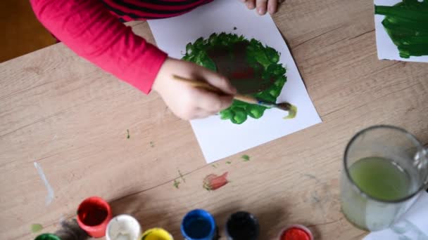 Childrens hands draw watercolors on surface of wooden table on paper. kid creativity, family hobby watercolor painting paintings — Stock Video