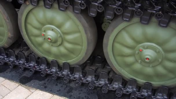 Detail of a caterpillar tank wheel military equipment close up — Stock Video