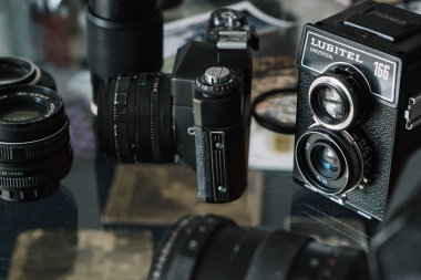 Belarus, Soligorsk, July 1, 2019: many old variety of Soviet film analog retro cameras and lenses close-up in photo studio or museum collection clipart