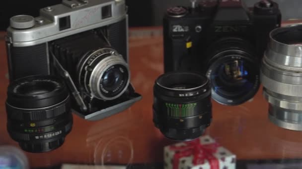 Bielorrusia, Soligorsk, 1 de julio de 2019: muchas viejas variedades de cámaras retro analógicas de película soviética y lentes de primer plano en un estudio fotográfico o en un primer plano del museo — Vídeo de stock