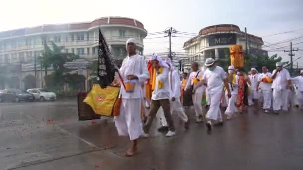 Tailandia, Phuket, 7 de octubre de 2019: Festival Vegetario Anual nueve dioses imperiales, procesión callejera a lo largo de las calles de la ciudad de Phuket, cerca de la gente del templo en ropas blancas con ritual religioso. — Vídeos de Stock