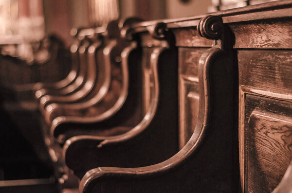 Wooden benches in the old cathedral. Baroque and Middle Ages.