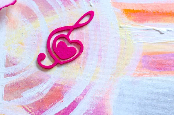 Treble clef with a heart on a beautiful background.Treble clef with a heart on a beautiful background.Photo background to Valentine\'s Day. Acrylic painting.