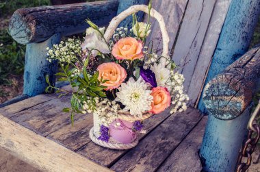 Bir buket turuncu gül ve eski ahşap arka planda kasımpatı. Çiçek buketi fotoğrafı..