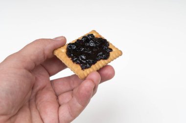 Bir elinde reçel olan bir bisküvi