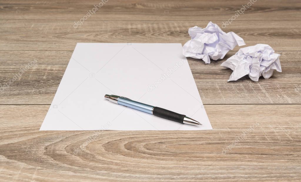 a sheet of white paper with a ball of crumpled paper