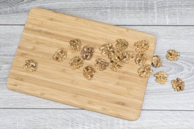 some shelled walnuts on the wooden table clipart