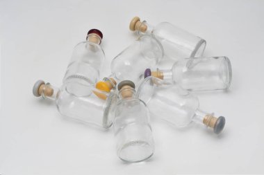 Masanın üzerinde renkli kapaklı küçük cam şişeler vardı.