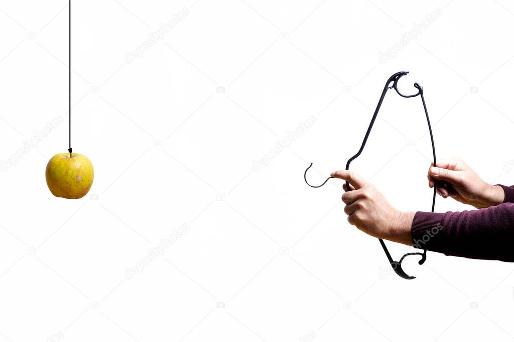 As William Tell hits the apple with a bow made by a coat hanger