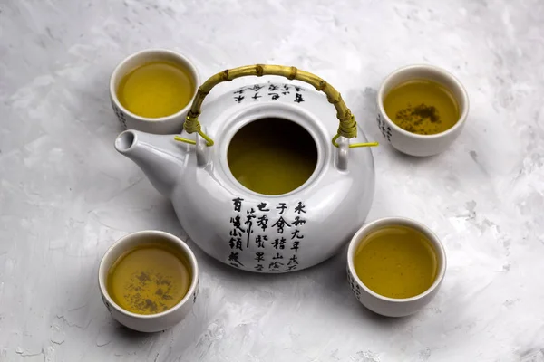 Top View Teapot Tea Bowls Hieroglyphs Concrete Backgroun — Stock Photo, Image