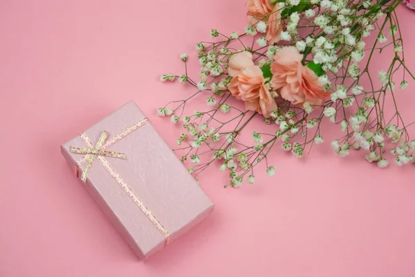 Üstten Görünüm pembe hediye kutusu ve bir pastel pembe çiçekler