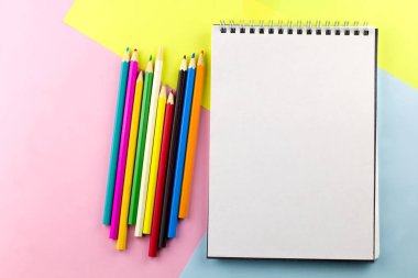 Üstten Görünüm parlak çalışma yer defter ile boş sheetcopy uzay ve parlak kalemler