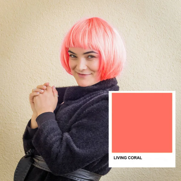 beautiful woman with hair colored in a color of 2019 Living Coral