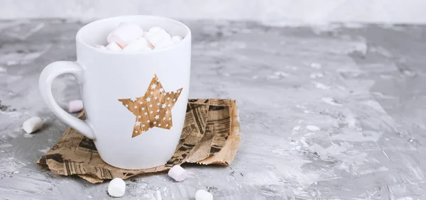 cute cup with marshmallows on a gray grunge concrete background