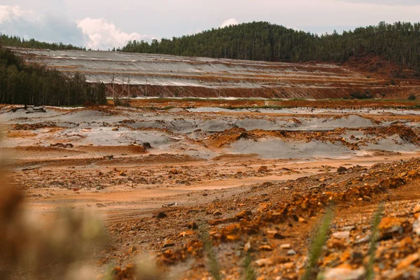 landscape with red soil polluted copper mining factory in Karabash, Russia, Chelyabinsk region, the dirtiest city on Earth