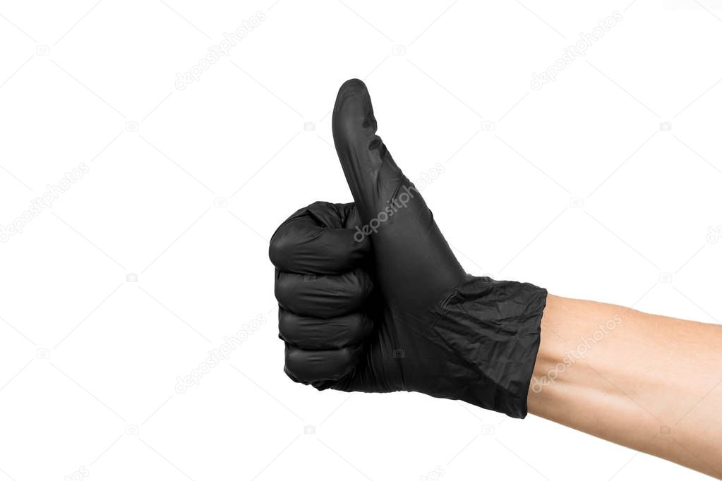 a man's hand in a black rubber glove shows a thumbs up isolated on a white background