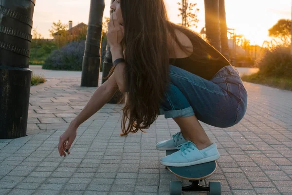 beautiful young woman with skateboard summer portrait