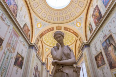 St. Petersburg, Russia - September 20, 2017: Lady statue made from stone on the center walkway inside State Hermitage Museum. clipart