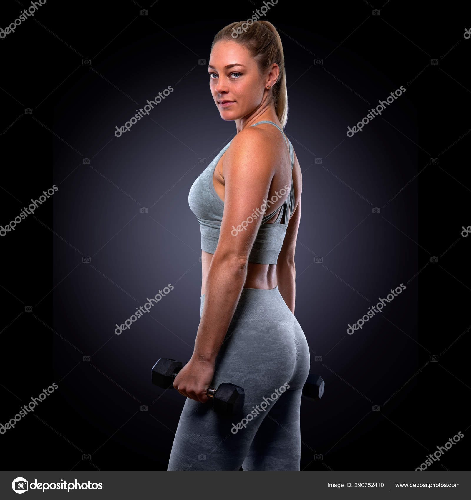 Powerful Muscular Attractive Female Exercising Weights Toned Arms Biceps  Using Stock Photo by ©elnariz 290752410