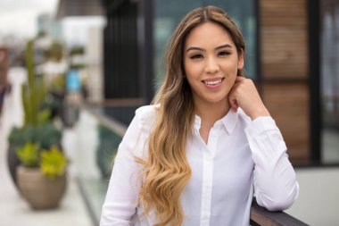 Şehirde genç bir 20's İspanyol Amerikalı kadın Portre baş çekim, güzel beyaz dişleri gülümseme ile gülümseyerek