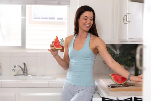 Female fitness and healthy eating lifestyle portrait, watermelon fruit meal before or after workout, in sportswear