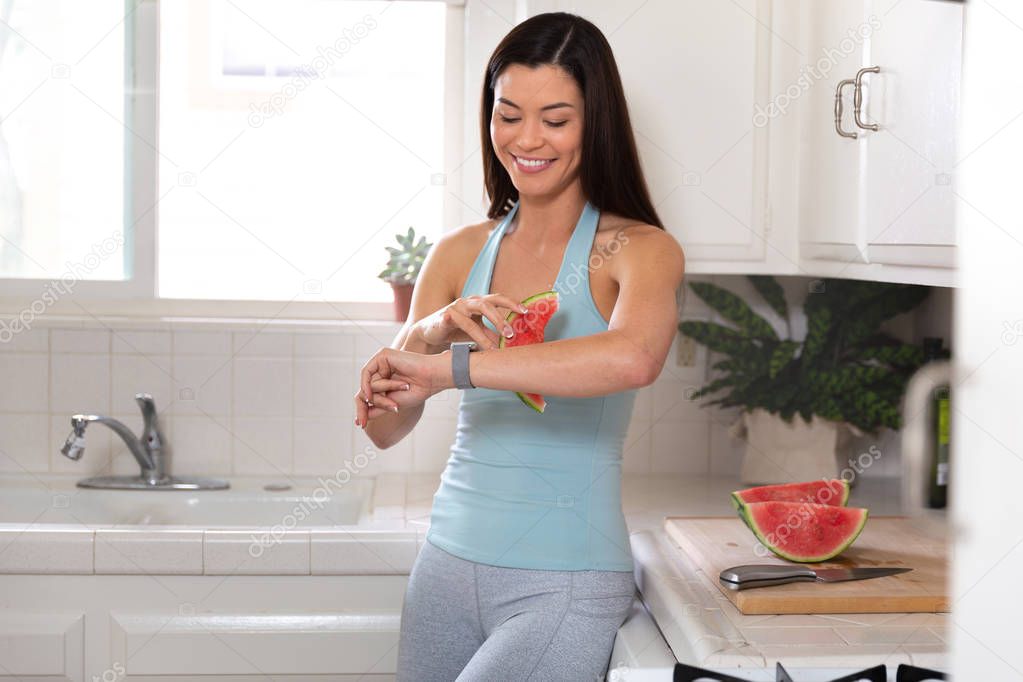Woman relaxing eating watermelon fruit breakfast after morning yoga exercise, slimming low calorie meal, happy and healthy