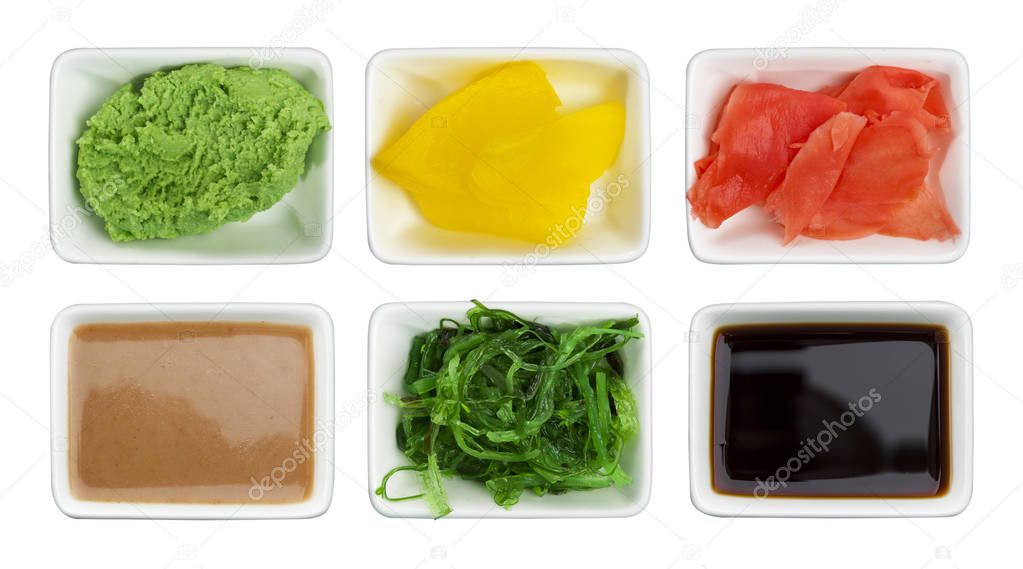 Japanese sushi spices. Soy sauce, wasabi, pickled ginger, chuka, sesame sauce and pickled radish isolated on white background